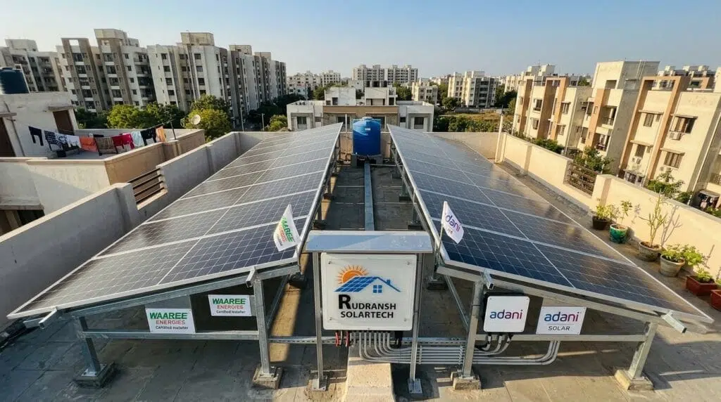 Side-by-side comparison of Waaree solar panels and Adani solar panels on a residential rooftop in Lucknow